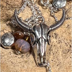SALE EF6 Earthly Findings-skull pendant and charms on silvertone chain.